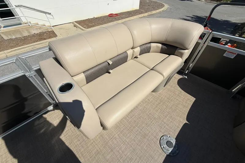 Slide: The Image of 2024 Sun Tracker Party Barge 22 DLX with beige seating and cup holder. - 10