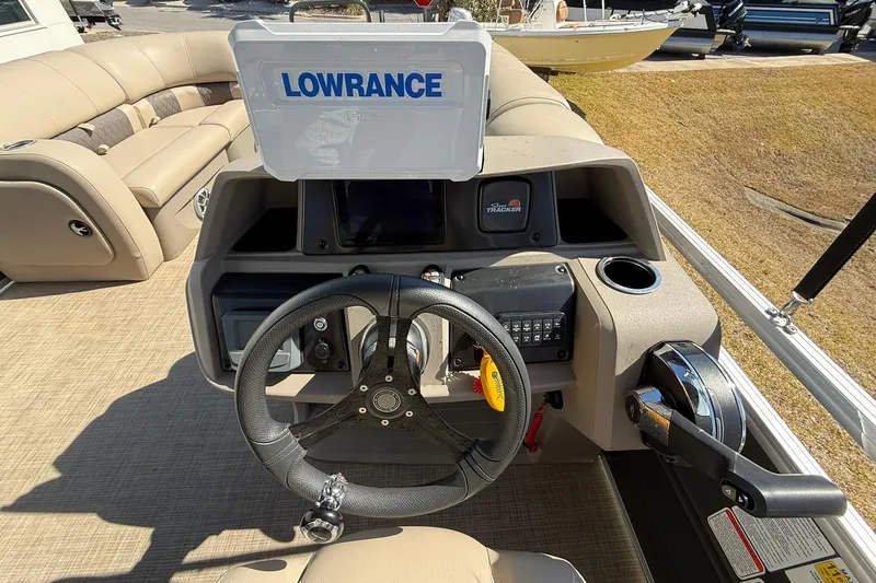 Slide: The Image of 2024 Sun Tracker Party Barge 22 DLX helm with Lowrance display and steering wheel. - 14