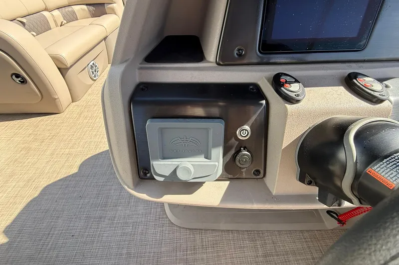 Slide: The Image of 2024 Sun Tracker Party Barge 22 DLX dashboard with controls and USB port. - 15