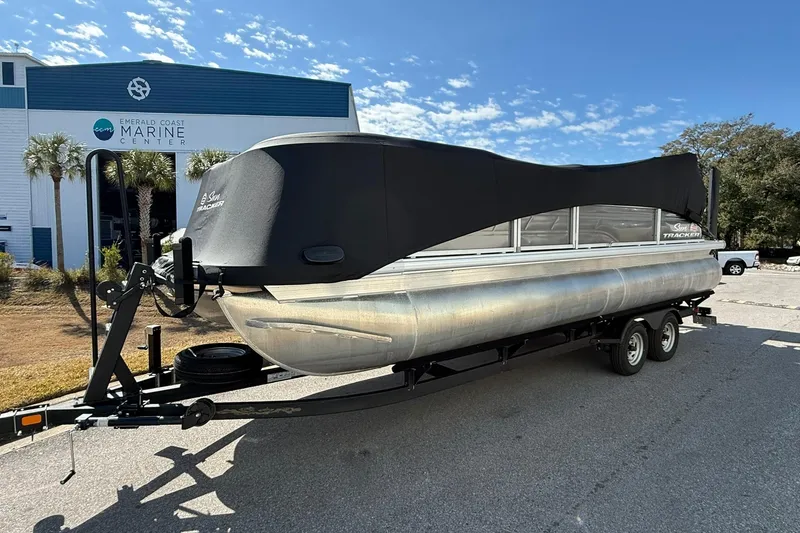 Slide: The Image of 2024 Sun Tracker Party Barge 22 DLX pontoon boat on trailer at marine center. - 5