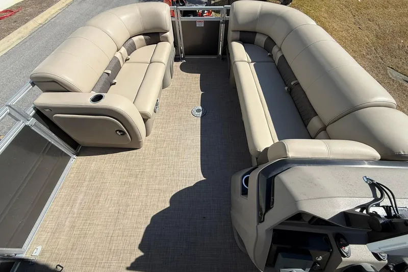 Slide: The Image of 2024 Sun Tracker Party Barge 22 DLX interior with beige seating and spacious layout. - 9