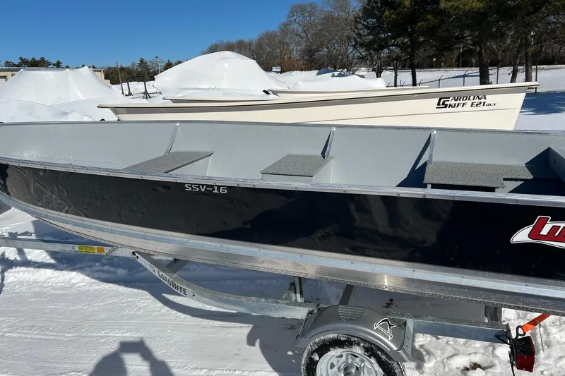 The Image of 2026 Lund SSV-16 boat on trailer in snowy outdoor setting. - 1