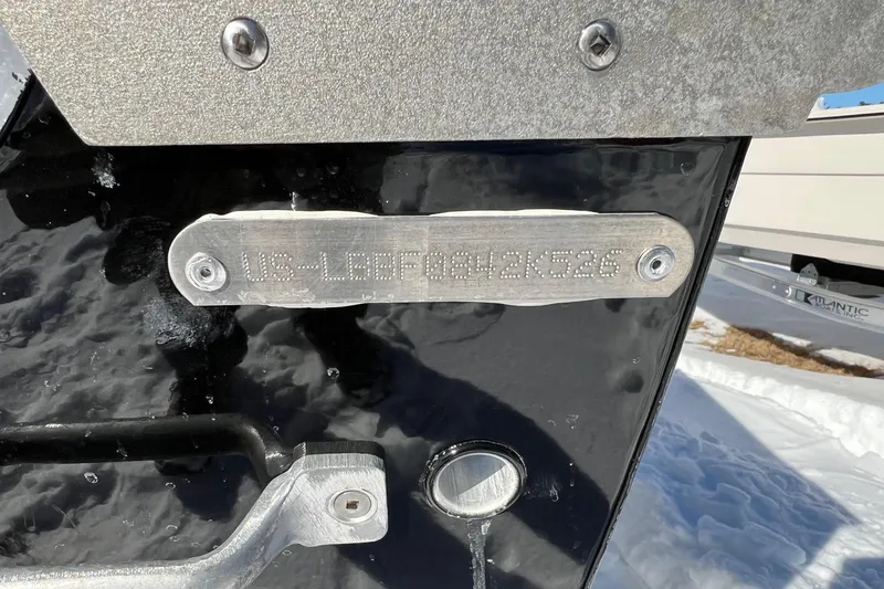 Slide: The Image of 2026 Lund SSV-16 boat hull identification number on metal plate in snowy setting. - 10