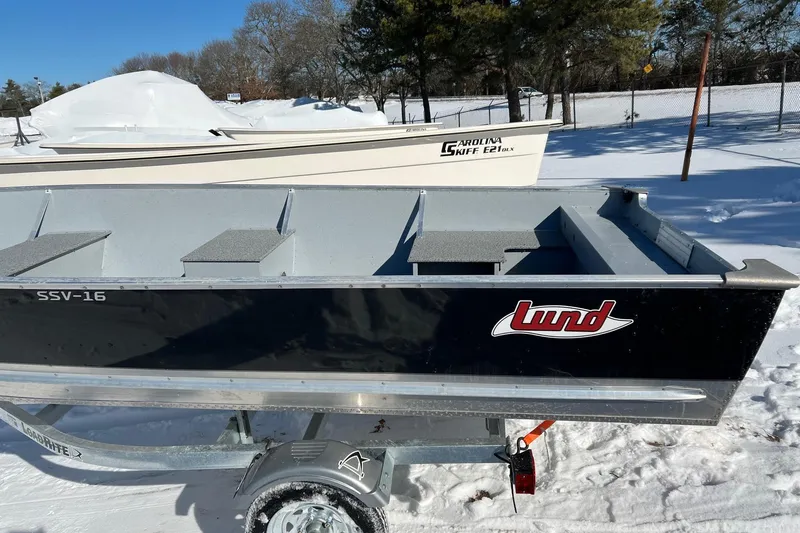 Slide: The Image of 2026 Lund SSV-16 boat on trailer in snowy outdoor setting. - 11