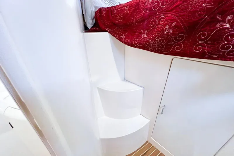 Slide: The Image of White interior steps and red quilt in 2000 Leopard 38 yacht cabin. - 101
