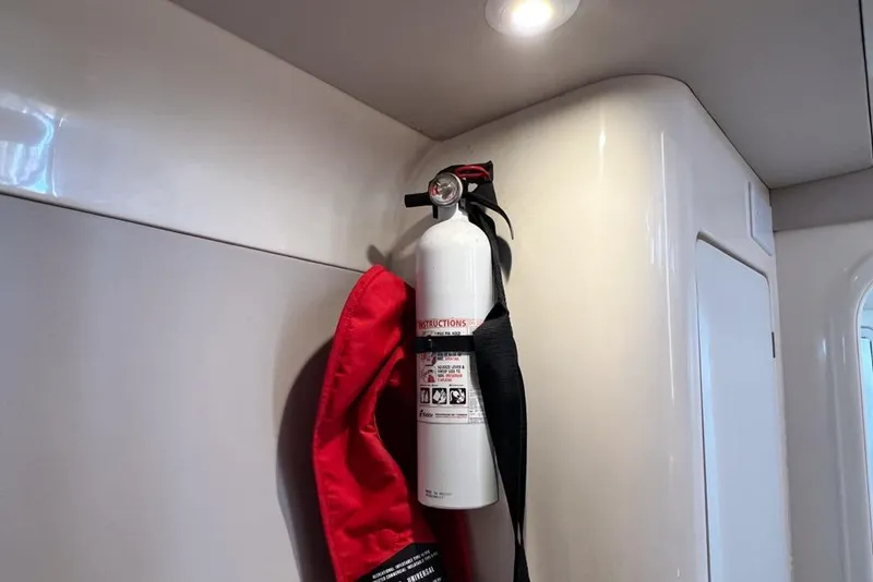 Slide: The Image of Fire extinguisher mounted inside a 2000 Leopard 38 yacht, with red safety cover. - 107