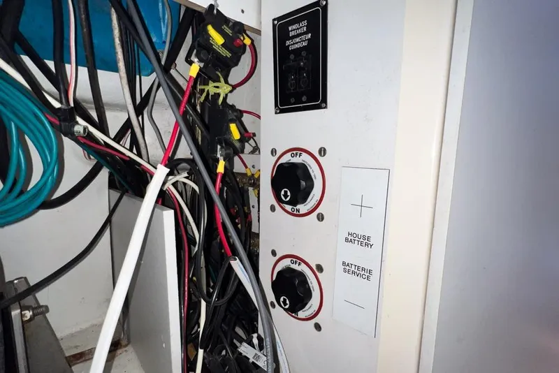 Slide: The Image of Electrical panel with switches and wiring in a 2000 Leopard 38 boat. - 108