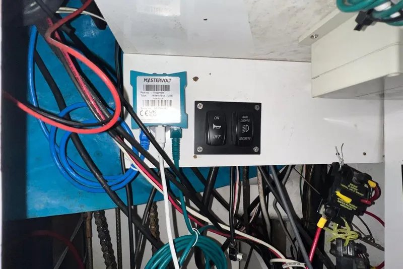 Slide: The Image of Electrical panel with Mastervolt USB, switches, and wiring in a 2000 Leopard 38 model. - 109