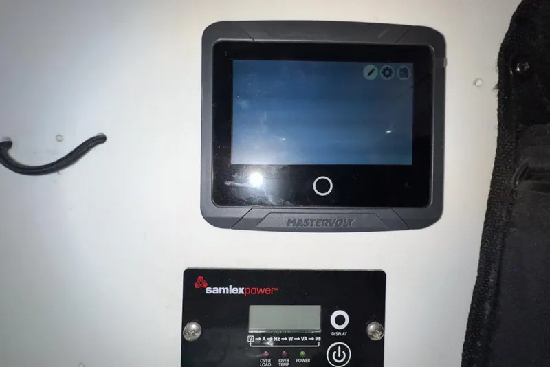 Slide: The Image of Mastervolt and Samlex Power control panels on Leopard 38, 2000 model. - 113