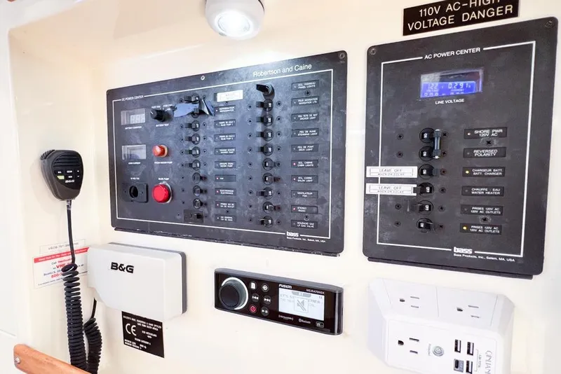 Slide: The Image of Electrical control panel on a 2000 Leopard 38 catamaran, featuring AC and DC power systems. - 116