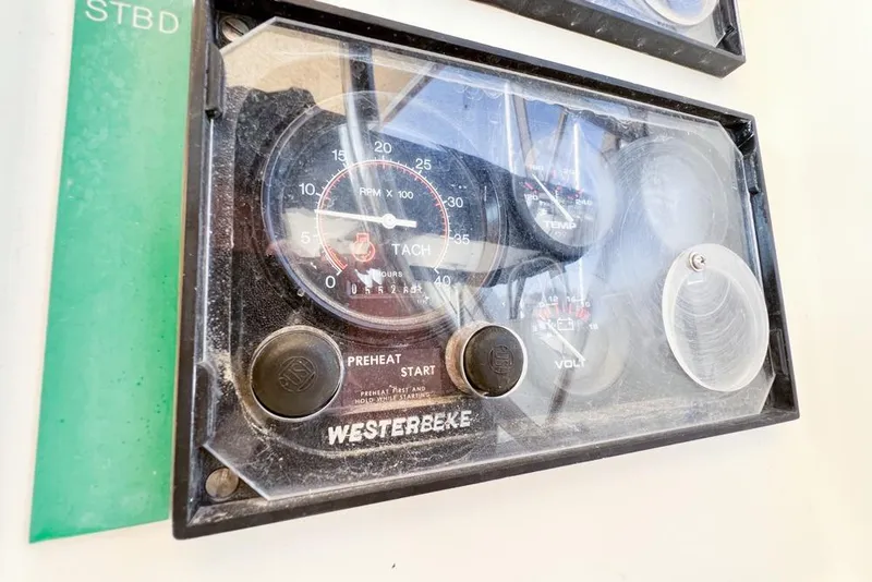 Slide: The Image of Control panel of a 2000 Leopard 38 with Westerbeke tachometer and gauges. - 117