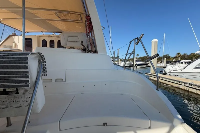 Slide: The Image of Leopard 38 catamaran deck view, 2000 model, docked at marina under clear blue sky. - 124