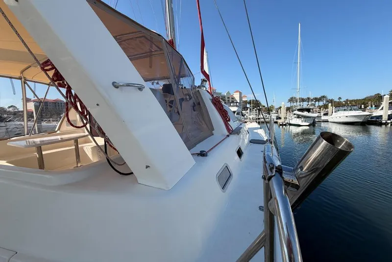 Slide: The Image of Leopard 38 catamaran from 2000 docked in a marina under clear blue skies. - 125