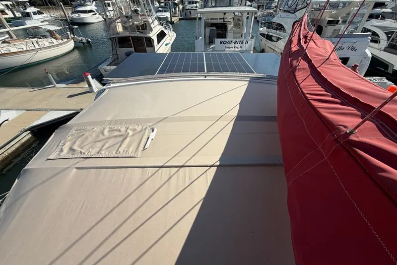 Slide: The Image of Leopard 38 catamaran, 2000 model, docked with solar panels and red sail cover. - 135