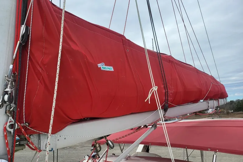 Slide: The Image of Leopard 38 catamaran, 2000 model, docked in a marina with other boats. - 14