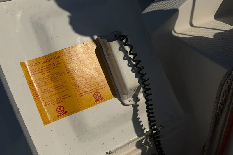 Slide: The Image of Anchor windlass guide on Leopard 38, 2000 model, with coiled cable and shadow. - 140