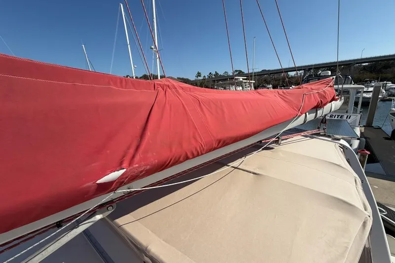 Slide: The Image of Red sail cover on Leopard 38 catamaran, docked in marina, clear blue sky. - 144