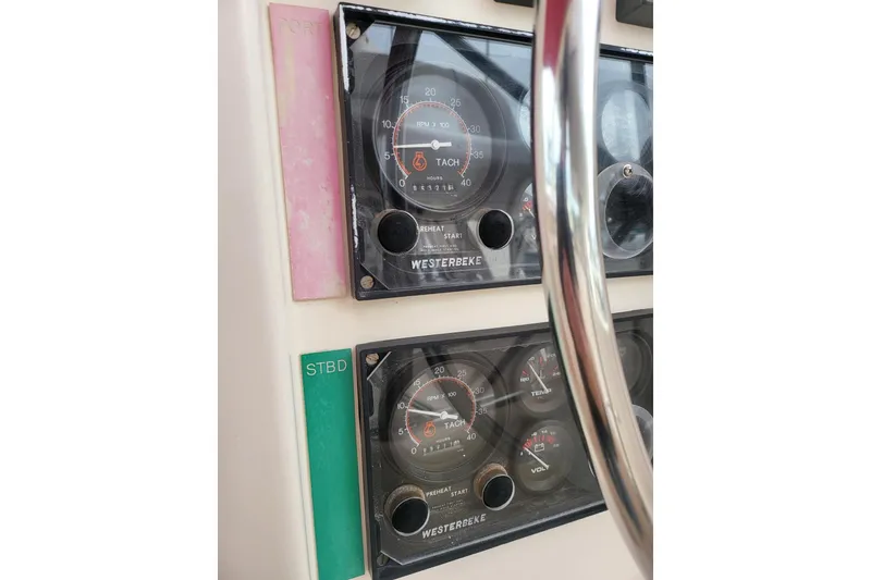 Slide: The Image of Leopard 38 catamaran docked at marina, featuring red sail, year 2000 model. - 15