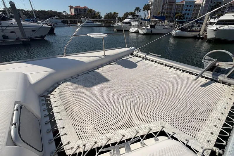 Slide: The Image of Leopard 38 catamaran's deck with netting, docked in a marina, 2000 model. - 160