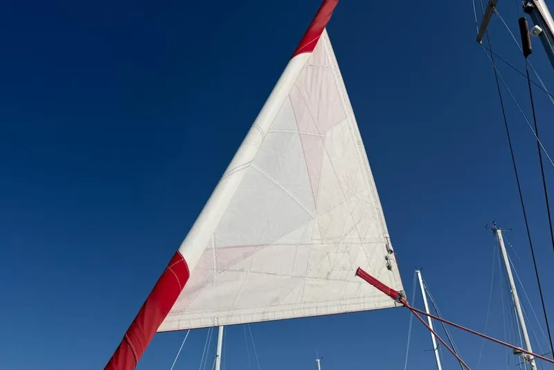 Slide: The Image of Sail of a 2000 Leopard 38 catamaran against a clear blue sky. - 164
