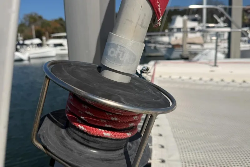 Slide: The Image of Close-up of a Leopard 38 sailboat winch with red rope, docked at a marina. - 165