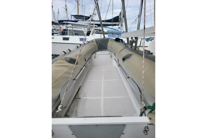 Slide: The Image of Leopard 38 catamaran with solar panels and dinghy docked at marina, 2000 model. - 17