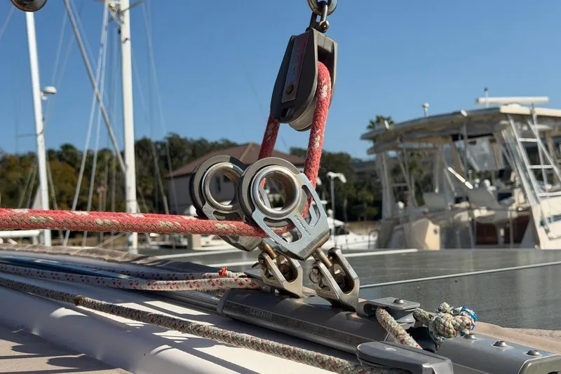 Slide: The Image of Close-up of rigging on a 2000 Leopard 38 catamaran, showcasing ropes and pulleys. - 175