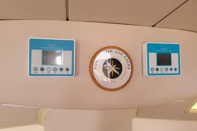 Slide: The Image of 2000 Leopard 38 catamaran docked in marina with red sail and dinghy. - 18