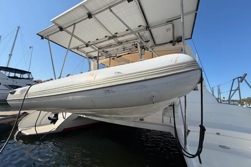 Slide: The Image of Leopard 38 catamaran with solar panels and dinghy, docked in a marina, 2000 model. - 186