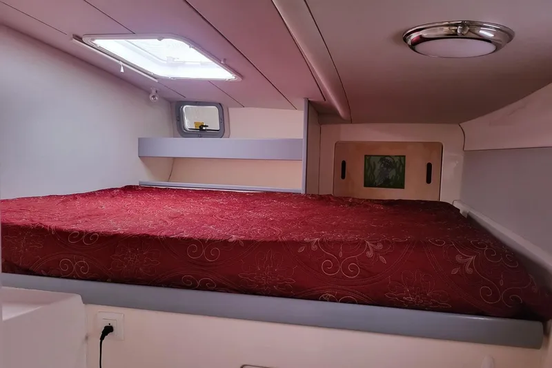 Slide: The Image of Underneath view of a 2000 Leopard 38 catamaran on water, showcasing hull and netting. - 24