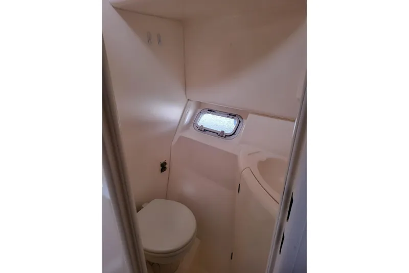 Slide: The Image of Underneath view of a 2000 Leopard 38 catamaran on water, showcasing hull and netting. - 25