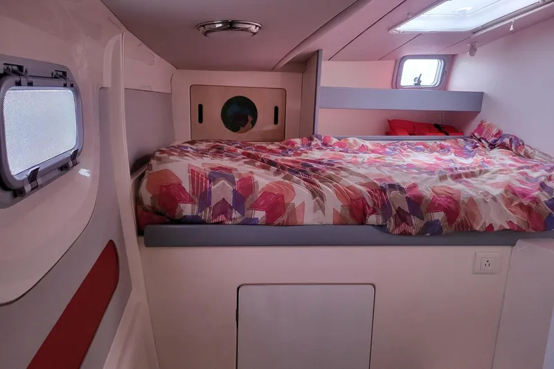 Slide: The Image of Leopard 38 catamaran docked at marina, 2000 model, with red sail. - 26