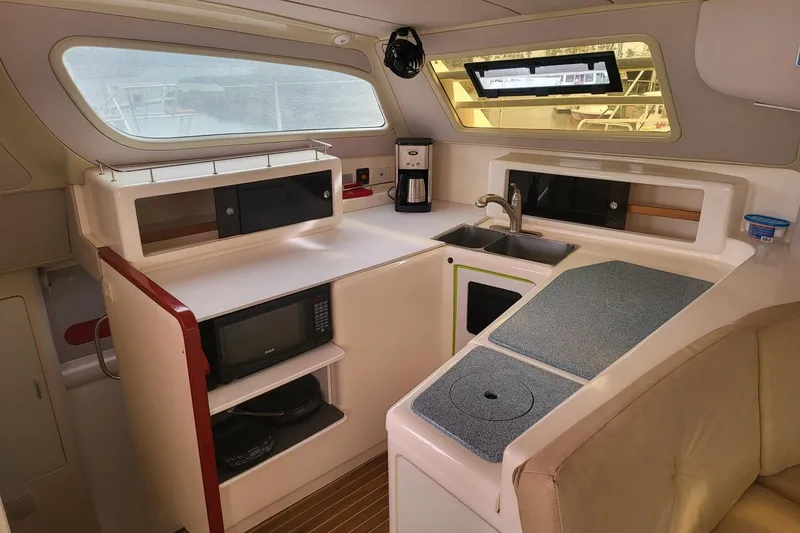 Slide: The Image of Aerial view of a 2000 Leopard 38 catamaran docked in a marina. - 29