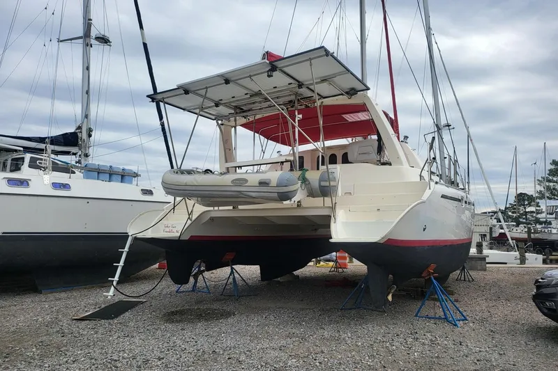 Slide: The Image of 2000 Leopard 38 catamaran docked in a marina under clear blue skies. - 3