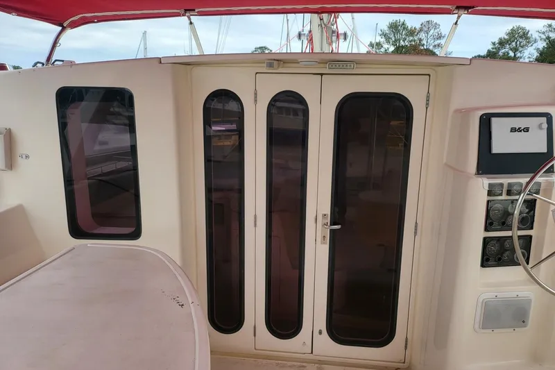 Slide: The Image of Helm of a 2000 Leopard 38 catamaran with navigation equipment and steering wheel. - 36