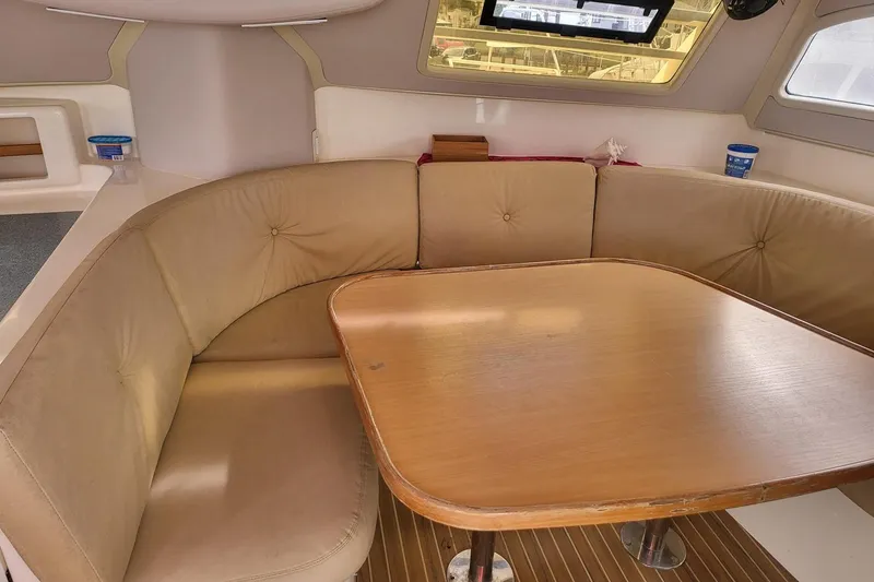 Slide: The Image of Helm of 2000 Leopard 38 catamaran with navigation equipment and marina view. - 38