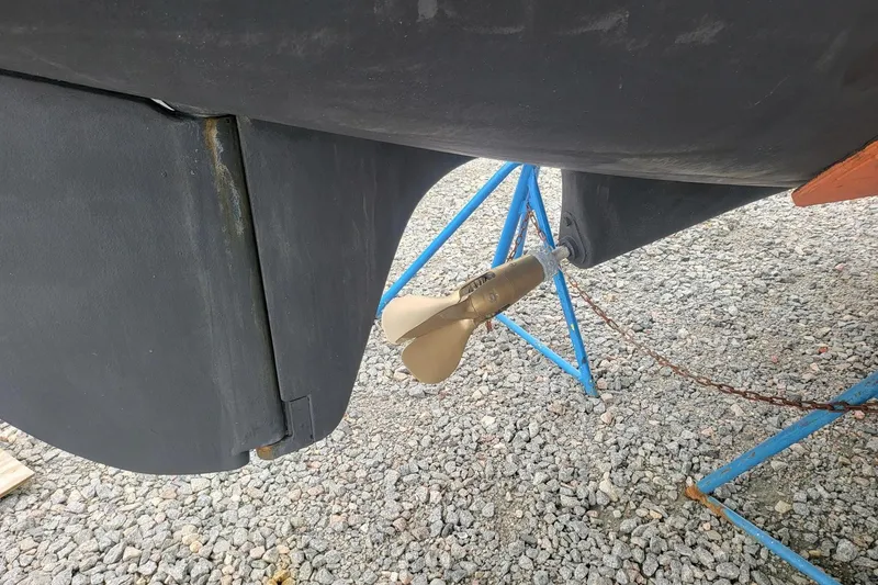 Slide: The Image of Leopard 38 catamaran docked in a marina, sunny day, bridge in background. - 4