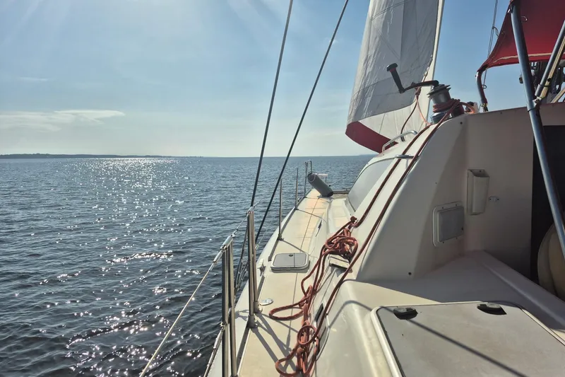 Slide: The Image of Interior view of a 2000 Leopard 38 catamaran, featuring a cozy seating area and helm. - 45