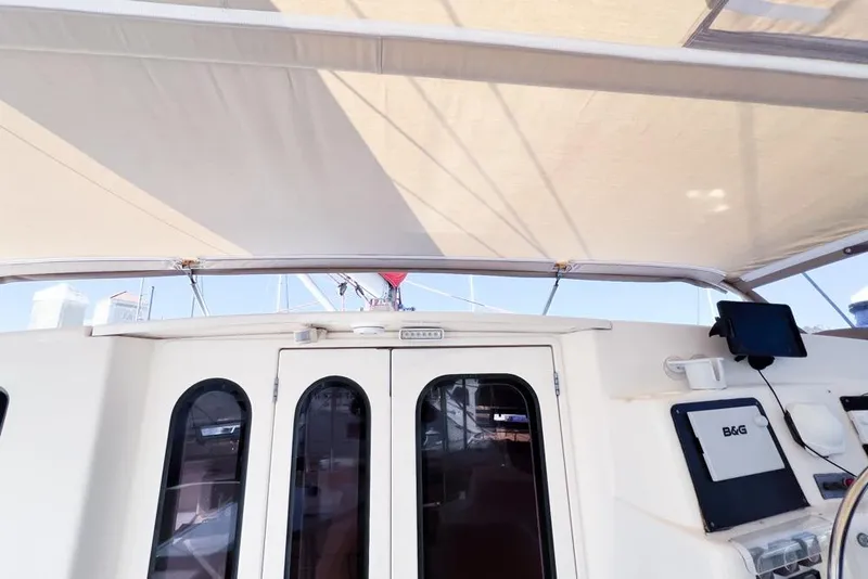 Slide: The Image of Leopard 38 catamaran cockpit with canopy, featuring navigation equipment, 2000 model. - 47