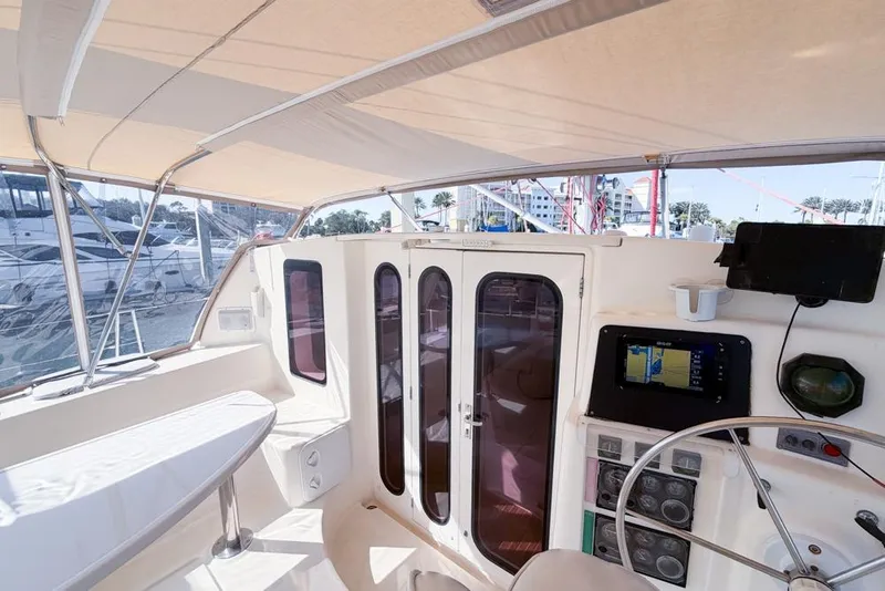 Slide: The Image of Interior view of a 2000 Leopard 38 catamaran cockpit with navigation equipment. - 48