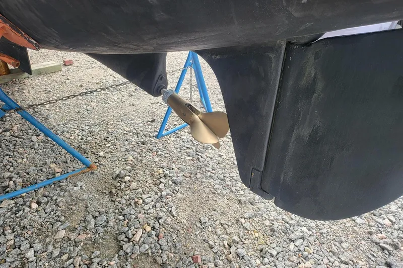 Slide: The Image of 2000 Leopard 38 catamaran docked in marina, front view with red sail. - 5