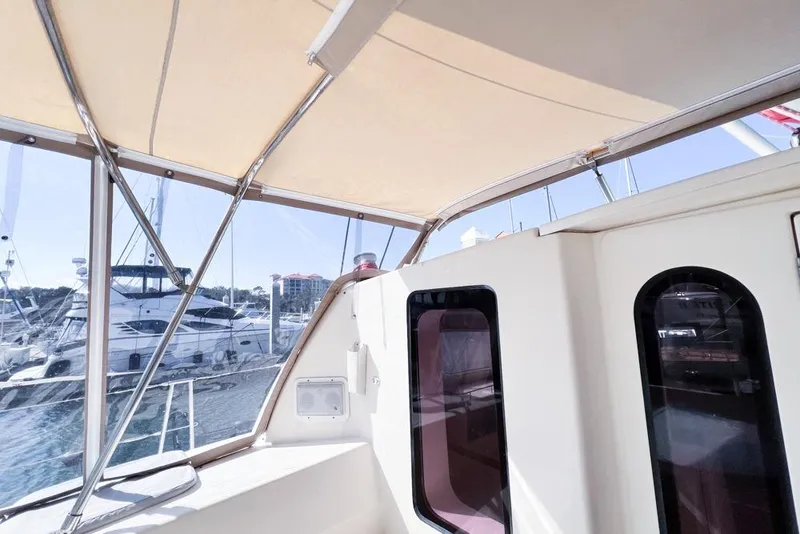 Slide: The Image of Leopard 38 catamaran interior view, showcasing windows and canopy, docked at marina. - 50