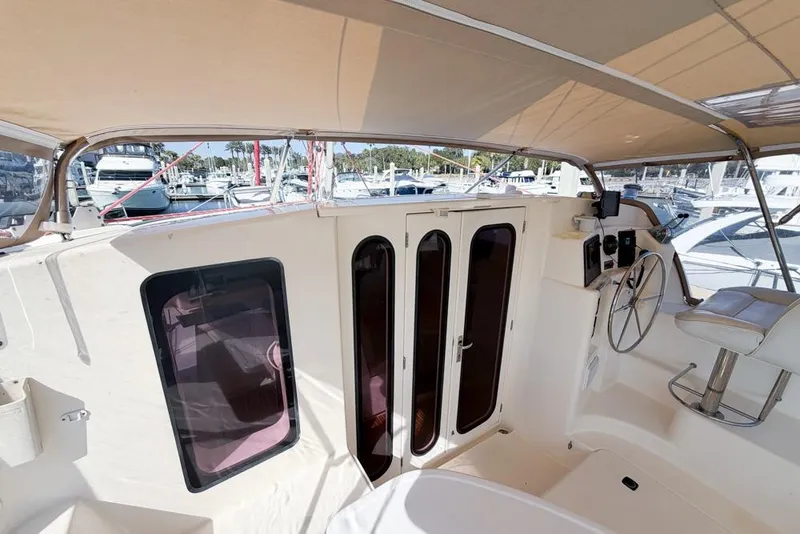 Slide: The Image of Interior view of a 2000 Leopard 38 catamaran with helm and seating area. - 51
