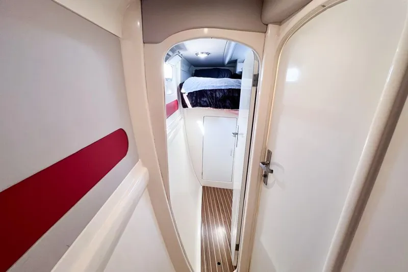 Slide: The Image of Interior of 2000 Leopard 38 yacht, featuring a cozy cabin with wood flooring. - 52