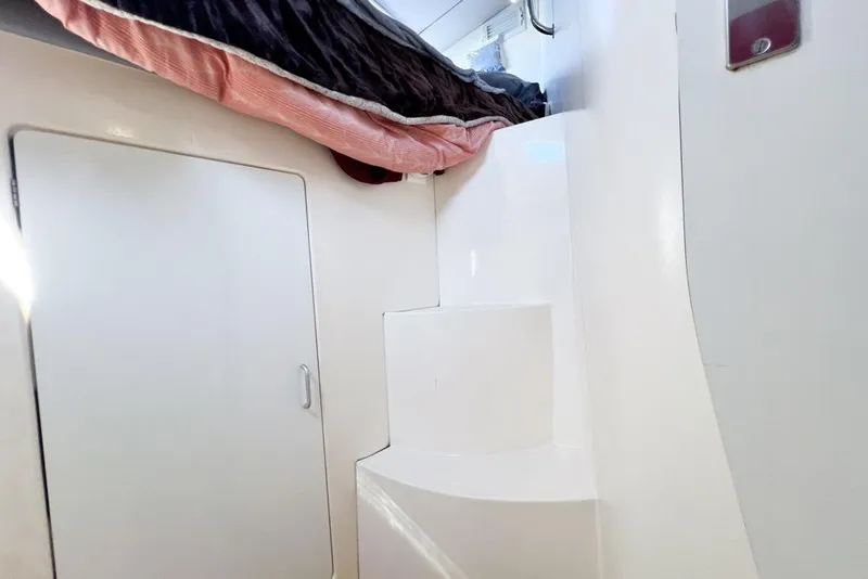 Slide: The Image of Interior of a 2000 Leopard 38 catamaran with white steps and a closed door. - 54