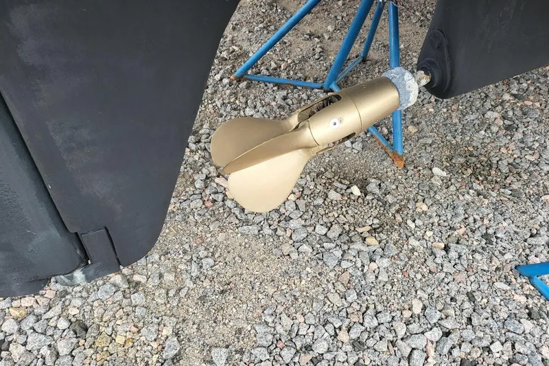 Slide: The Image of Leopard 38 catamaran, 2000 model, docked in a marina under clear blue sky. - 6