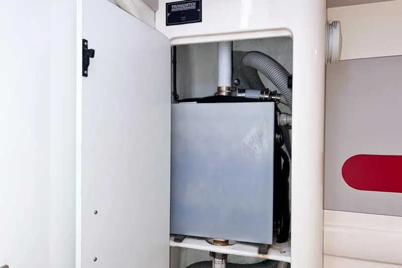 Slide: The Image of Leopard 38 (2000) yacht interior showing a water tank system in a compartment. - 68