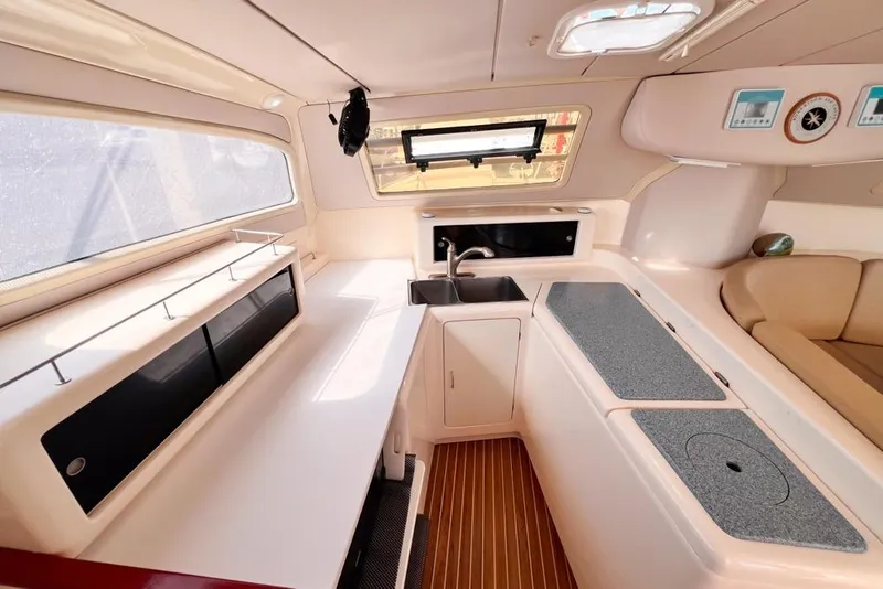 Slide: The Image of Interior of a 2000 Leopard 38 yacht, featuring a modern kitchen and seating area. - 73