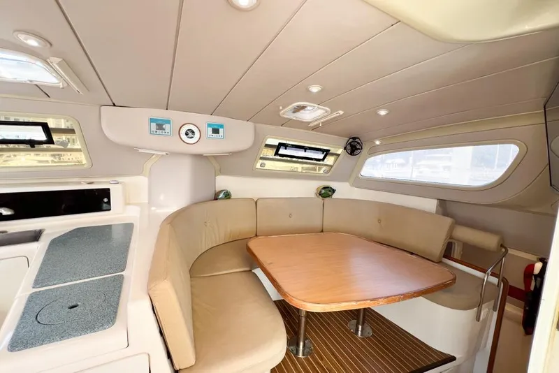 Slide: The Image of Interior of 2000 Leopard 38 yacht with cozy seating and wooden table. - 81