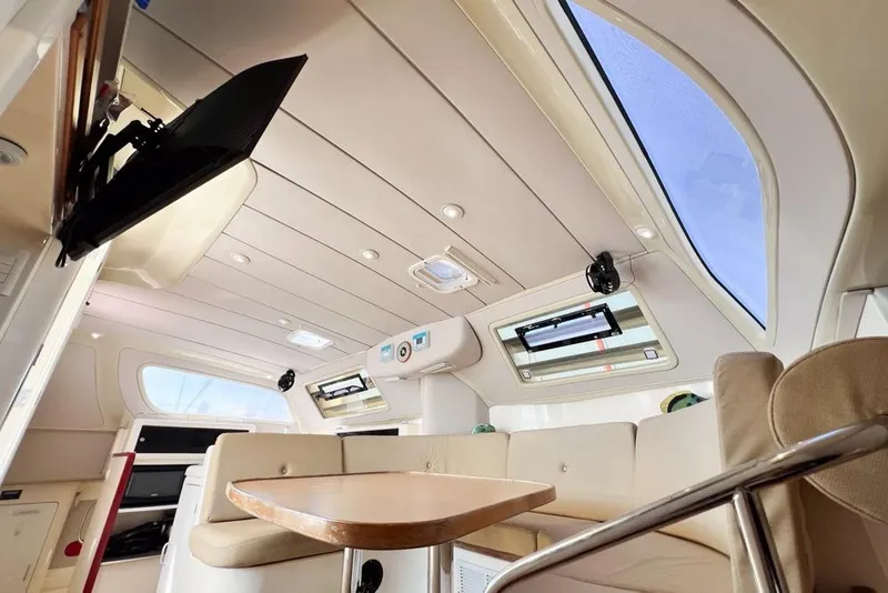 Slide: The Image of Interior of a 2000 Leopard 38 catamaran, featuring a cozy dining area and modern amenities. - 85